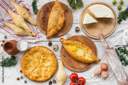 Traditional Georgian adjara khachapuri and Kolkh khachapuri on the table. Homemade baking. Top view. Flat lay