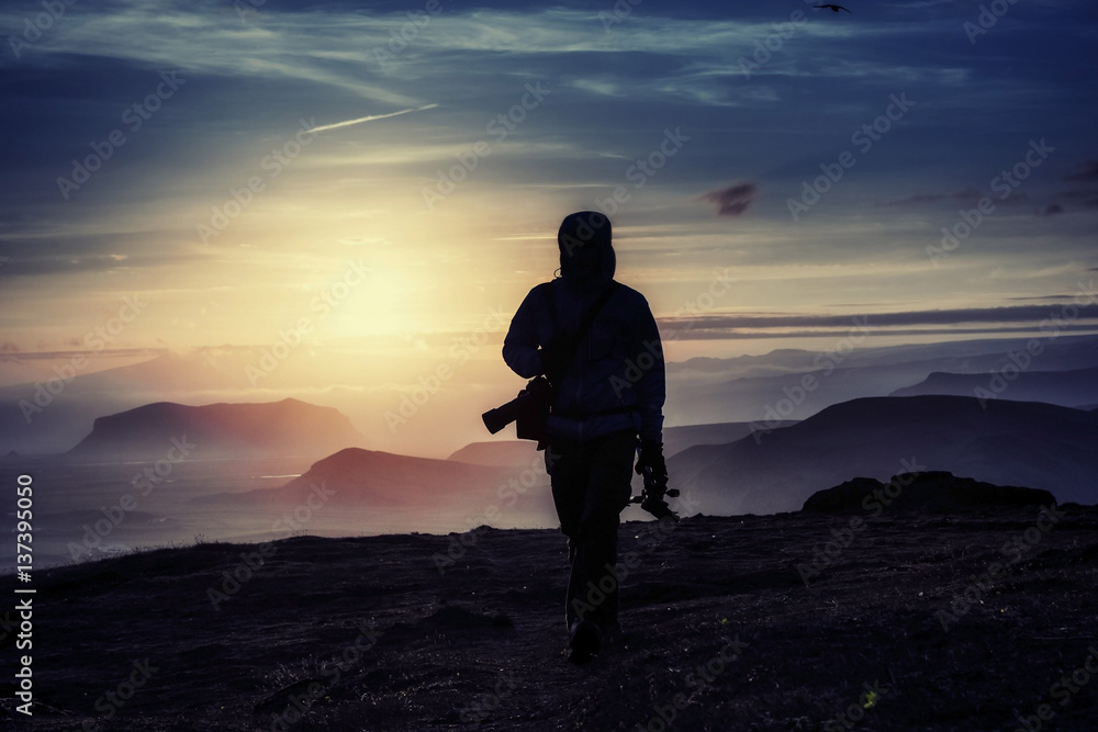 Happy man standing on a cliff at sunset. Happy man standing on a cliff at sunset.