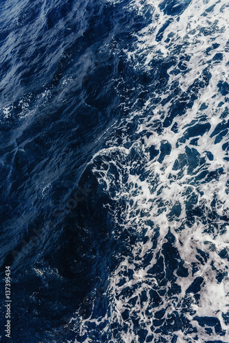 Textural background. Blue waves of the sea 