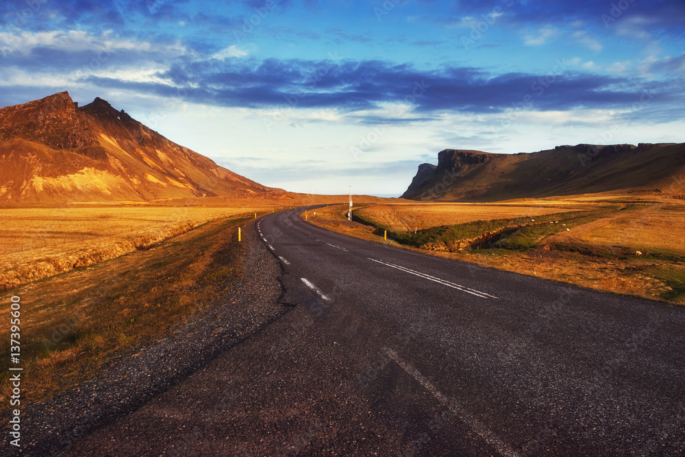 Asphalt road to the mountains. Beauty world Iceland
