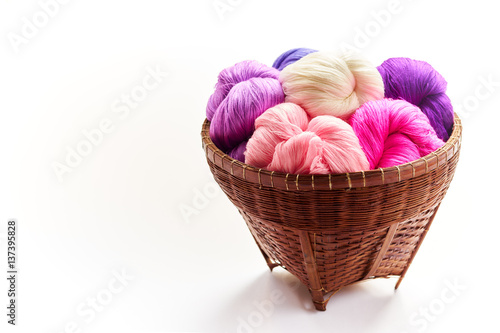 Group of pure colorful cotton in rattan basket on white isolated background.