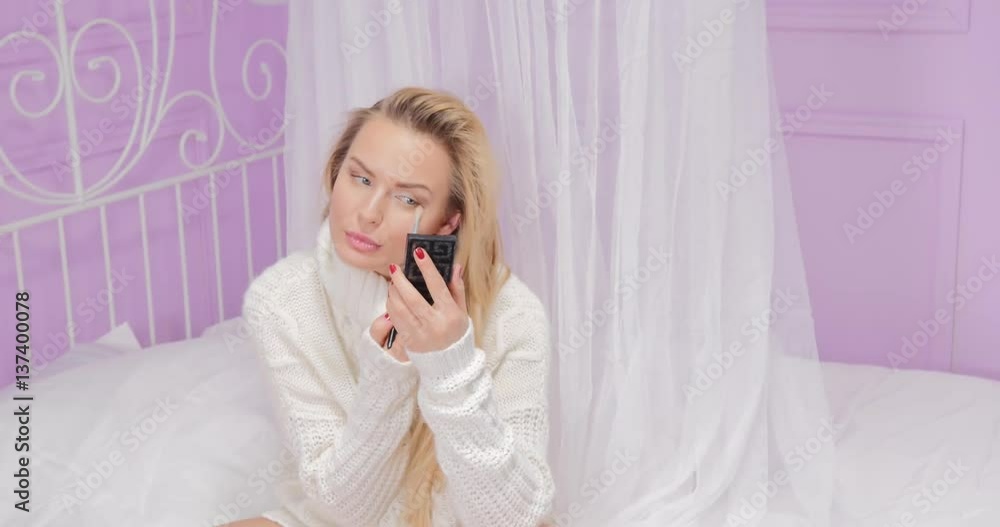 Blonde woman relaxing in bed. Blonde woman relaxing in bed.