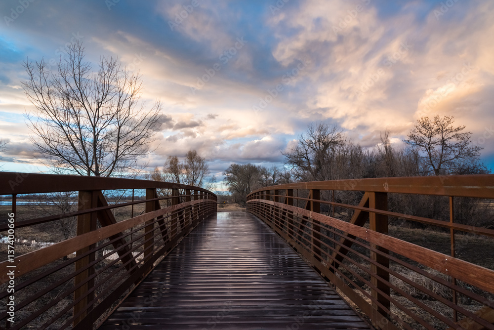 Naklejka premium Rain-Slick Footbridge At Sunset