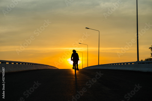 Silhouette of a bike on sky background on sunset