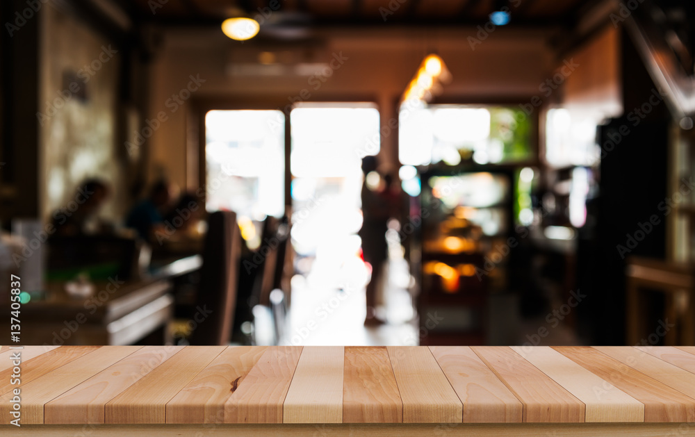Empty wood table top with blur of people in coffee shop Empty wood table top with blur of people in coffee shop