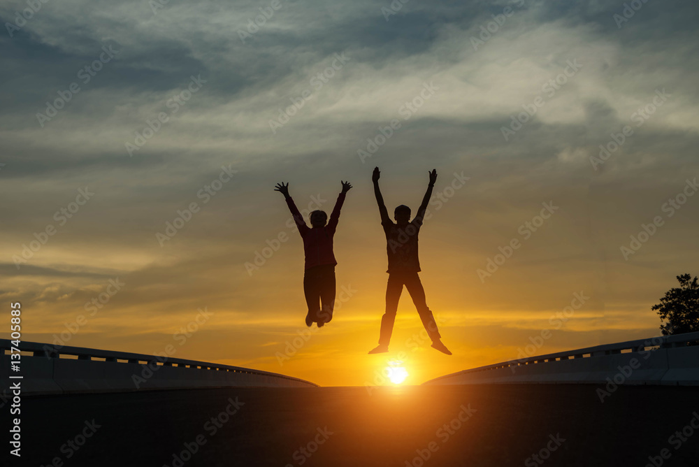 silhouette couples Jumping at sunset