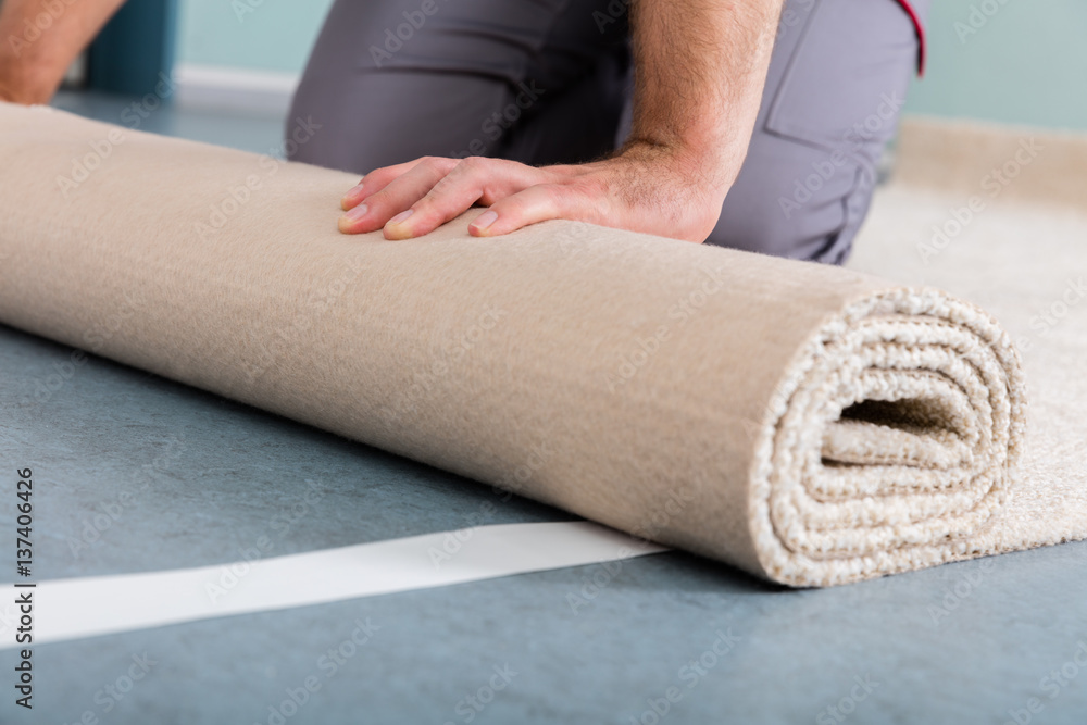 Worker's Hands Rolling Carpet