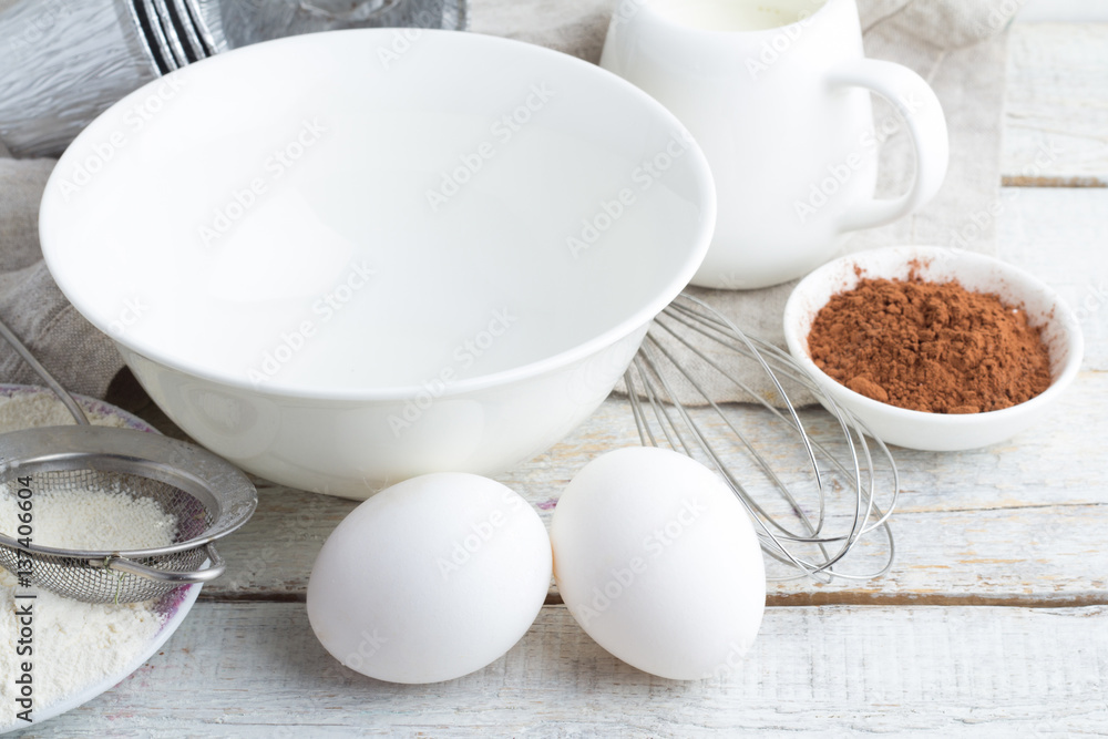 utensils and ingredients for baking on a wooden background close up utensils and ingredients for baking on a wooden background close up