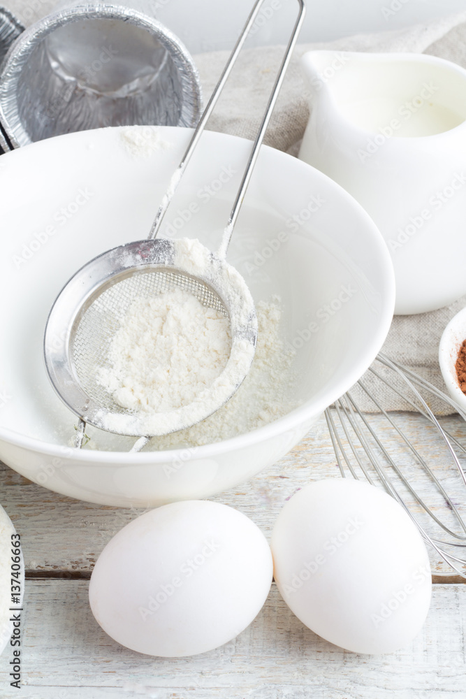 bowl with flour, eggs, cocoa and milk bowl with flour, eggs, cocoa and milk