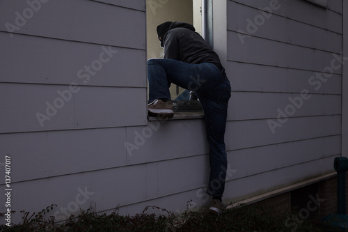 Burglar Entering House Through Window
