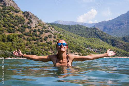 Beautiful girl in swimsuit and sunglasses in the sea © kuzenkova
