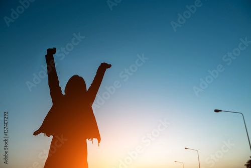 Silhouette of a woman with evening sky.