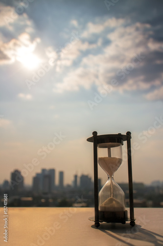 Hourglass against city view