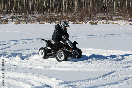 Child Driving a Quad in the Snow
