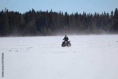 Quading Across a Windy Lake In Winter