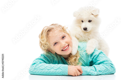 Little girl with a samoyed puppy © Natalia Chircova