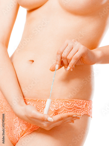 Woman with tampon in monthly cycle. photo