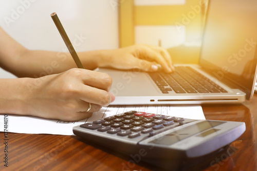 woman working with calculator, business document and laptop computer notebook,business  finance, selective focus