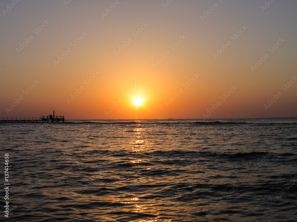 Red Sea in Egypt during sunrise with blue water and pier