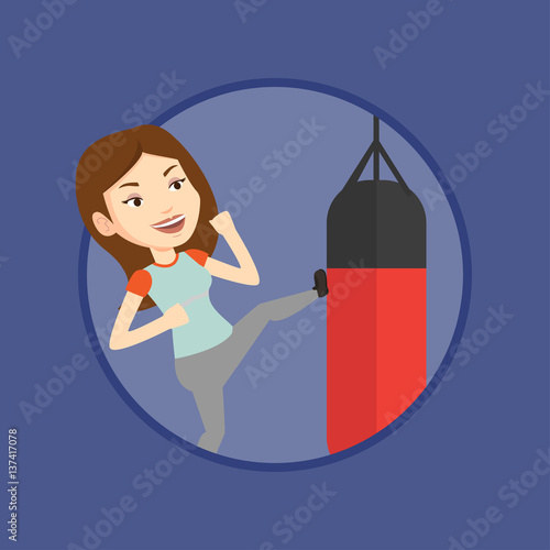 Woman exercising with punching bag.