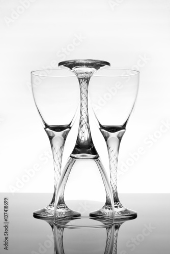 Wine glasses on glossy table surface
