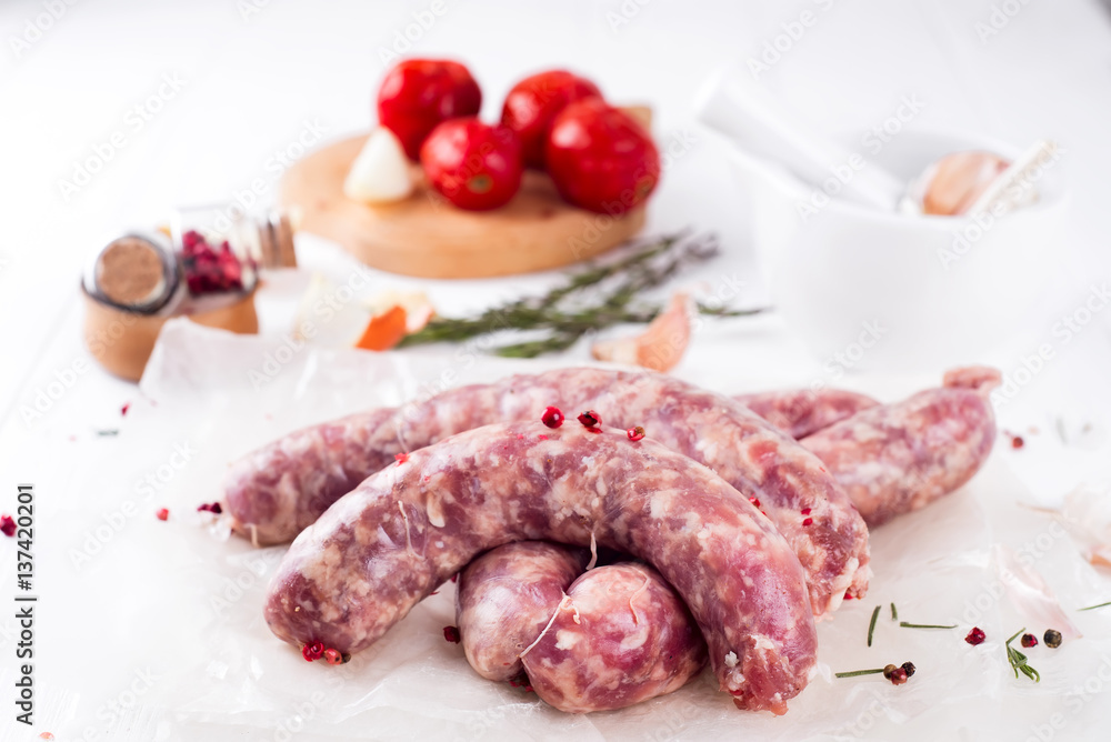 Raw sausages on slate Raw sausages on slate