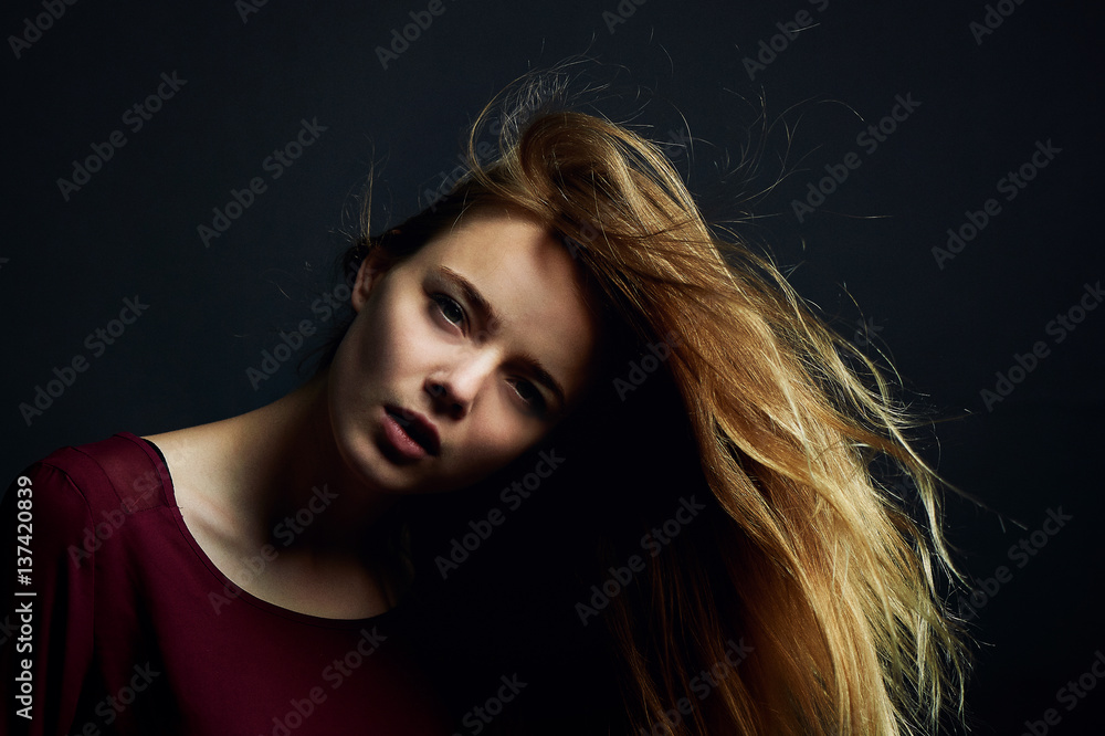 The hand in her hair. Beautiful young girl dancing. Hair flying. Shooting in Studio The hand in her hair. Beautiful young girl dancing. Hair flying. Shooting in Studio