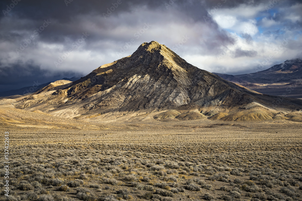 Mountain in the Nevada Desert with dramatic light and clouds.  Chalk Mt.  Middle Gate, NV