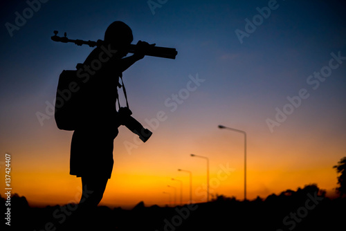 silhouette of a photographer who shoots a sunset.