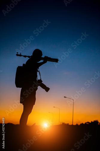 silhouette of a photographer who shoots a sunset.