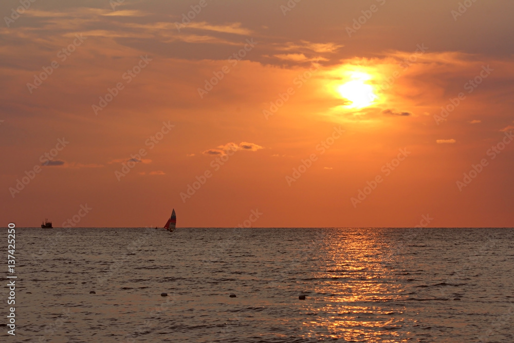 Pacific Ocean orange sunset on the beach in koh mak thailand