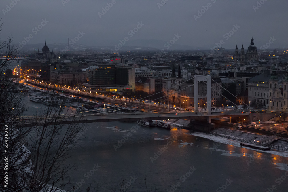 View of the city at dusk with a bridge in the foreground. Budapest Hungary