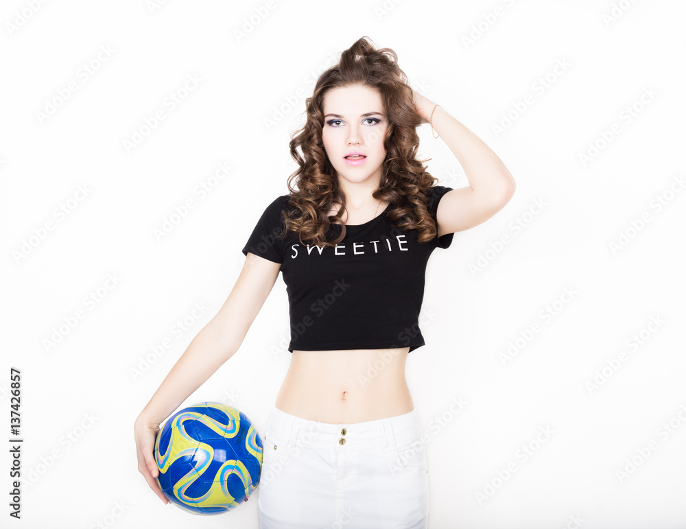 Young beautiful curly girl with professional make-up, holding a ball Young beautiful curly girl with professional make-up, holding a ball