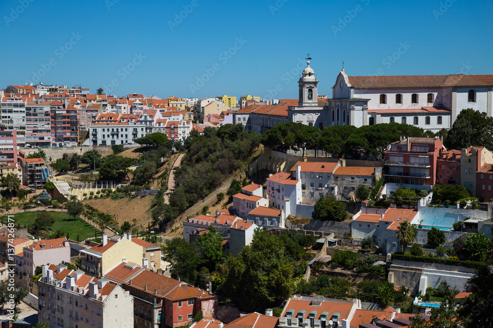 Rooftop city view from the Castle of Saint George in Lisbon, Portugal. City red roof and monastery view.