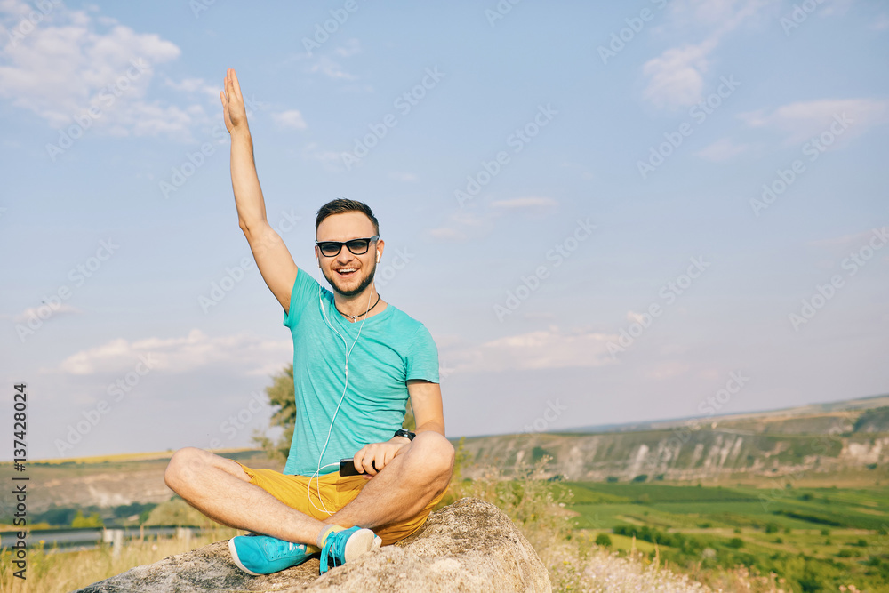 Young man smiling and enjoying sunny summer day