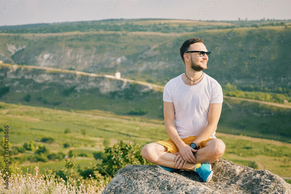 Young man smiling and enjoying sunny summer day