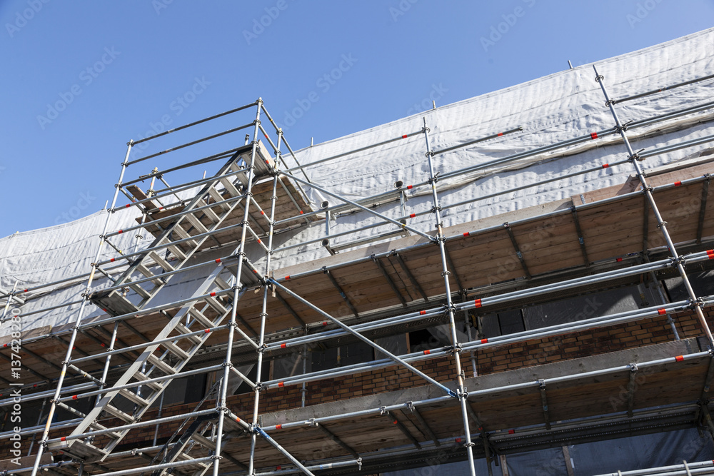scaffolding under blue sky on new housing facility in the netherlands