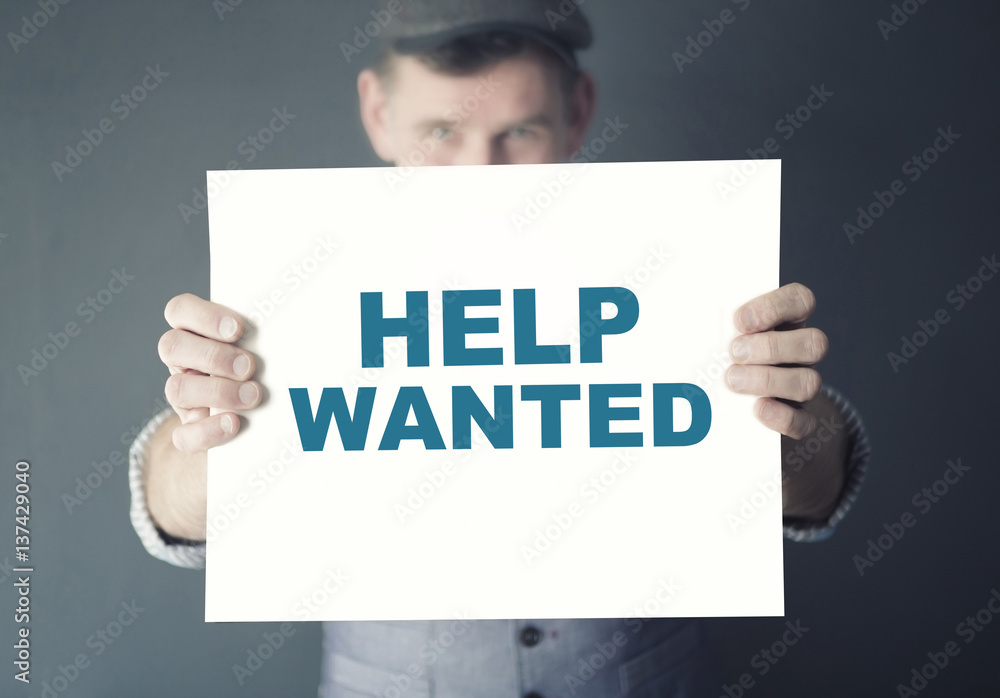 man holding sign with the words Help Wanted man holding sign with the words Help Wanted