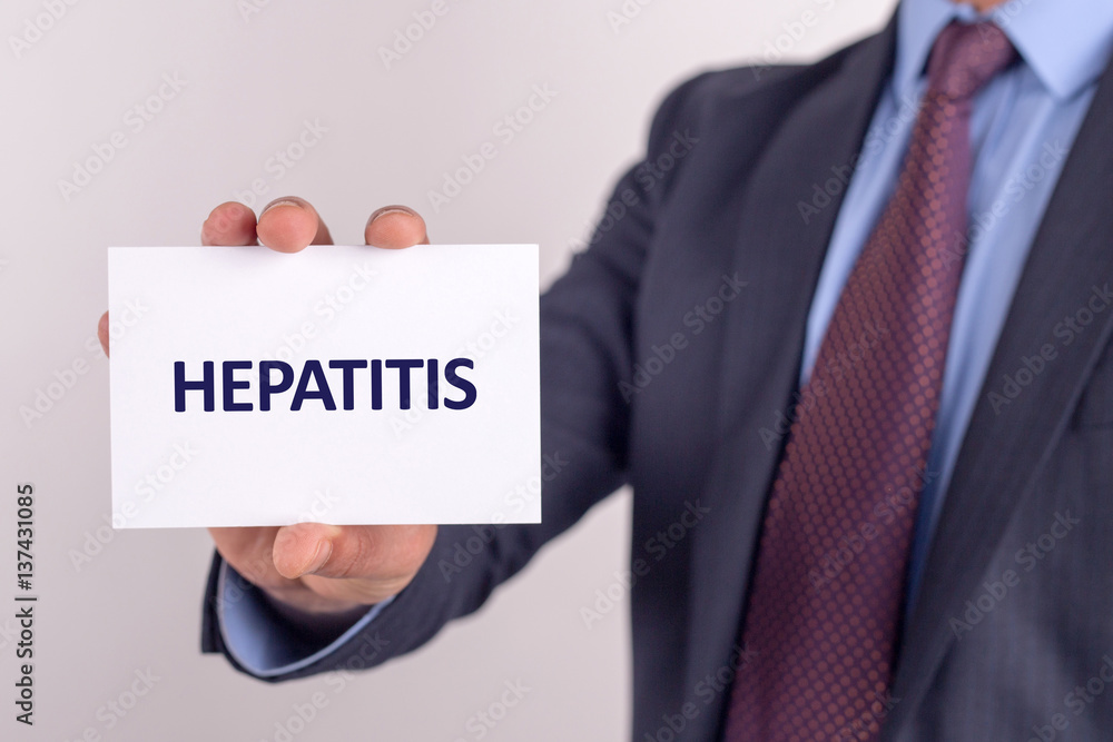 Man showing paper with HEPATITIS text Man showing paper with HEPATITIS text