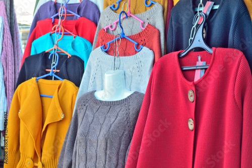 Selling women's jackets and sweaters made of wool on the market photo