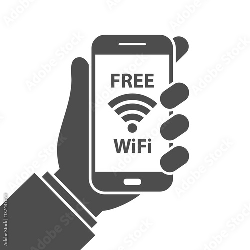 Free wifi sign concept. Hand holding mobile phone with free wifi text and wifi symbol on the display
