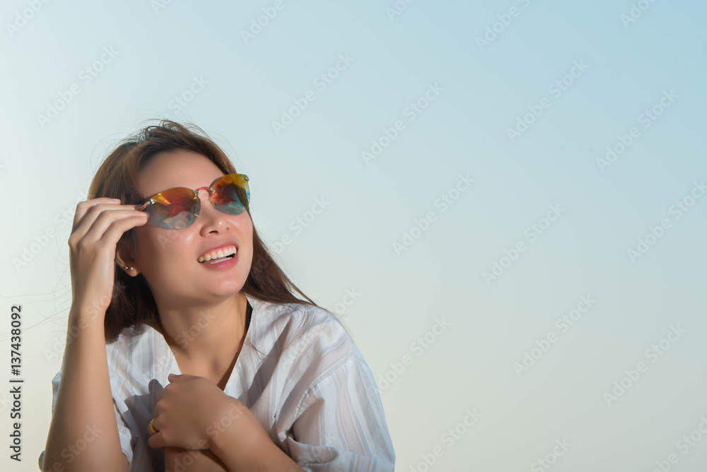 young woman happy sitting on the rock with the beach young woman happy sitting on the rock with the beach