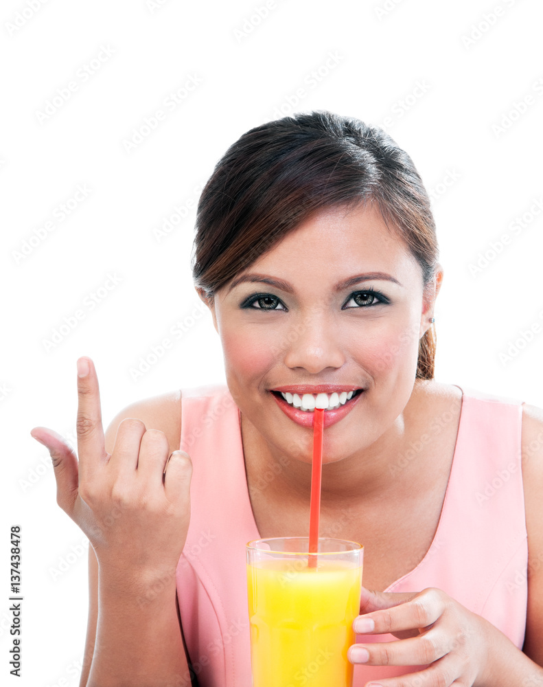 Young woman sipping orange juice on white background Young woman sipping orange juice on white background