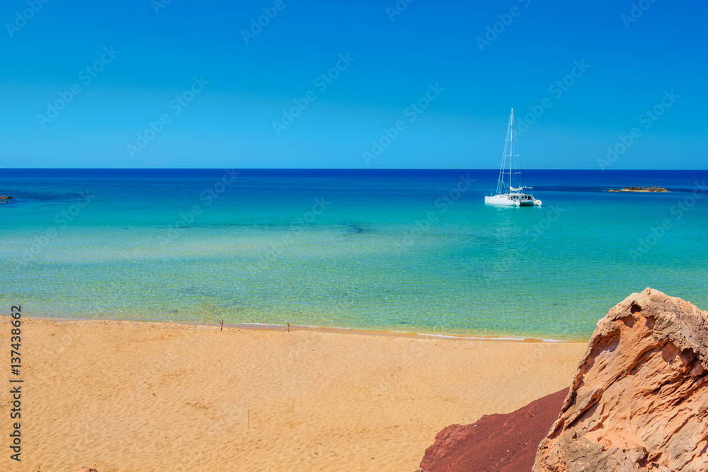 Cala Del Pilar beach with saturated golden send at Menorca island, Spain.