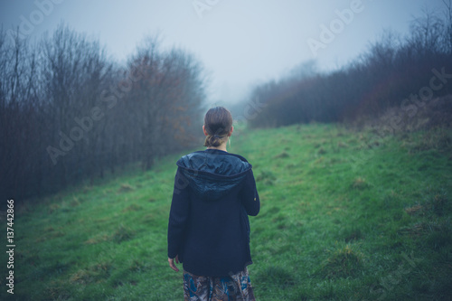 Young woman walking the mist