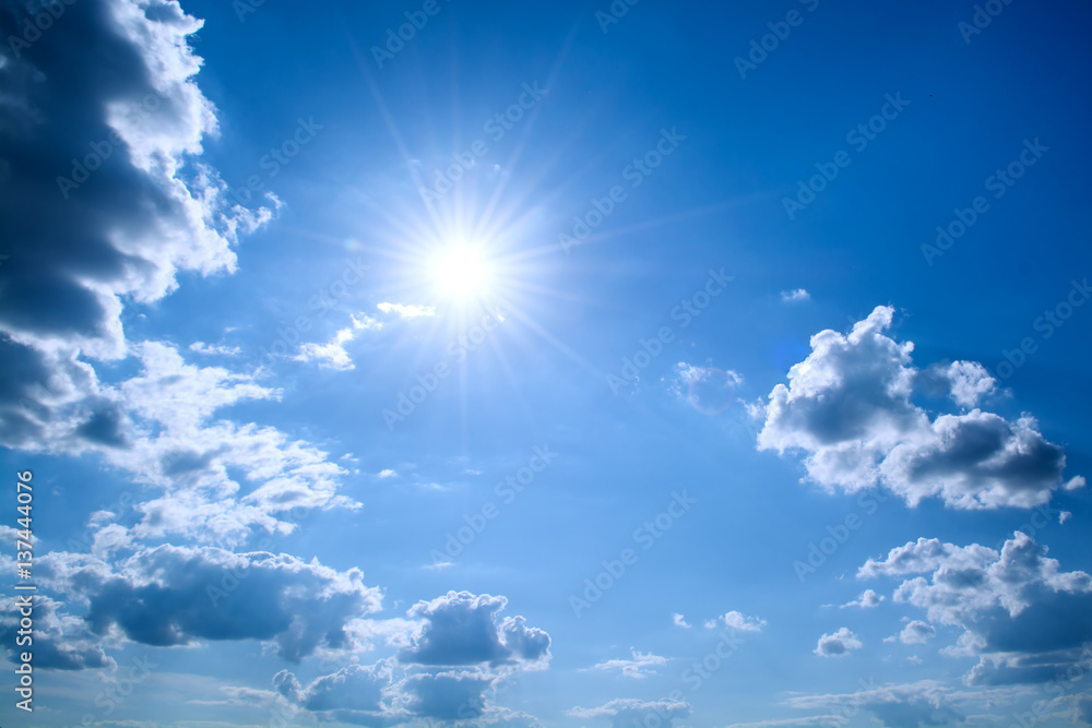 Sun rays against a blue sky in the clouds