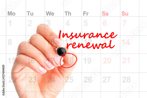 Insurance renewal reminder in calendar handwritten  by woman hand