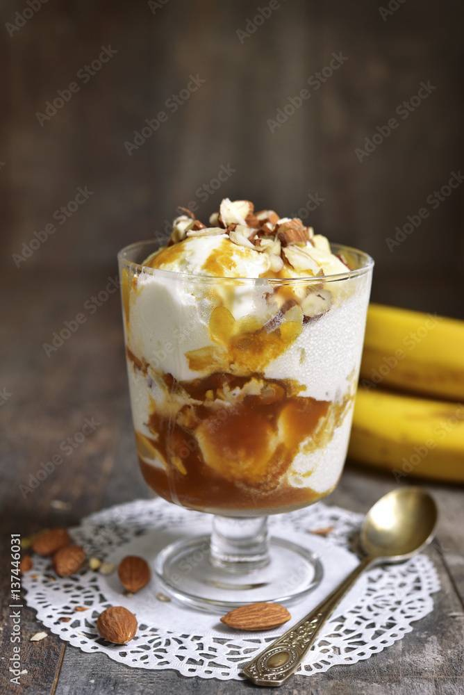 Portion of ice cream dessert with banana and homemade caramel. Portion of ice cream dessert with banana and homemade caramel.