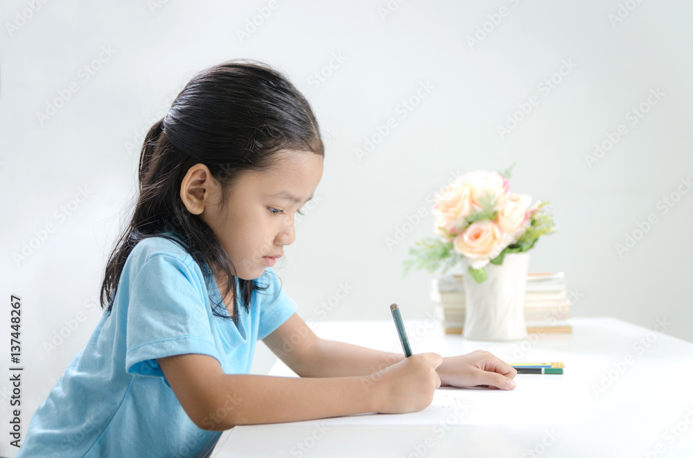 Portrait of Asian little girl drawing with pencil Portrait of Asian little girl drawing with pencil