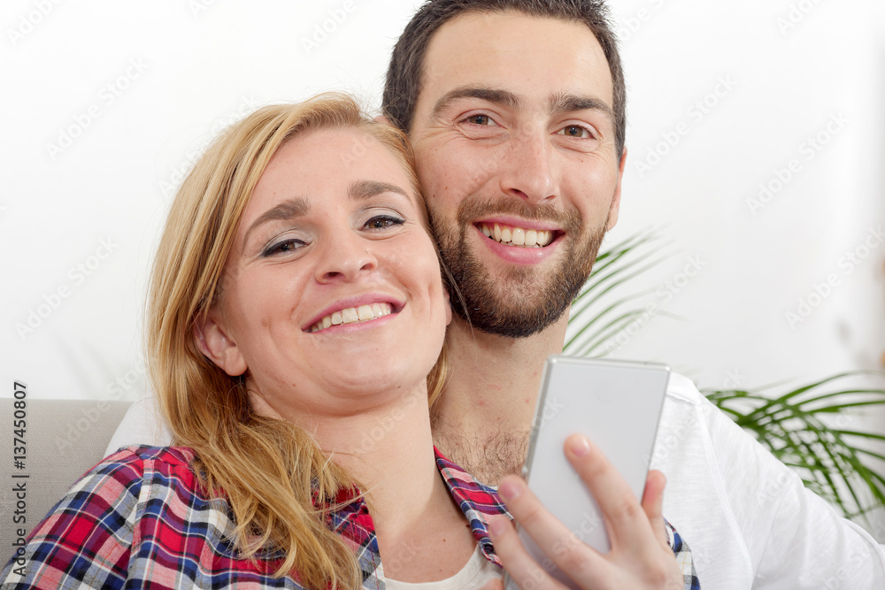 portrait of happy young couple with phone